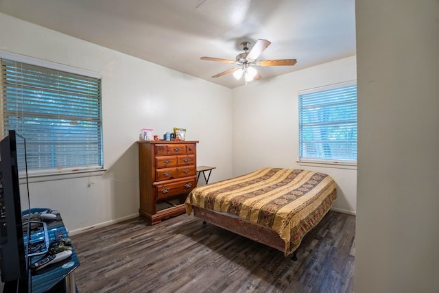 bedroom with baseboards, ceiling fan, and wood finished floors