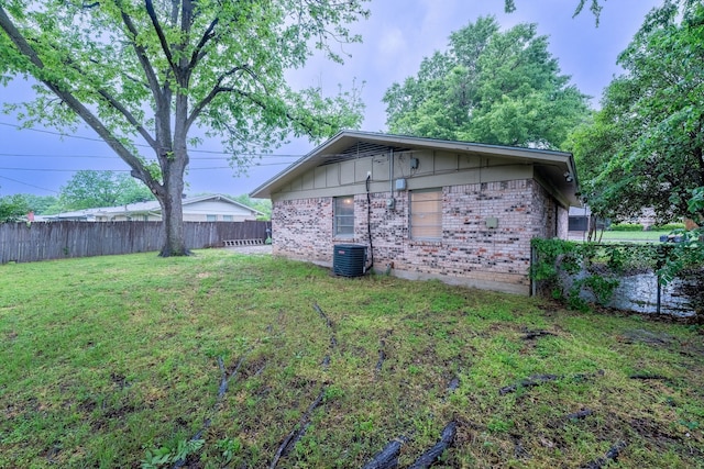 exterior space featuring fence and central AC unit