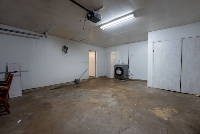 garage featuring a garage door opener and washer / dryer