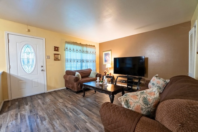 living room featuring plenty of natural light, baseboards, and wood finished floors