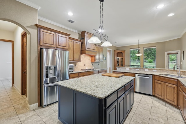 kitchen featuring visible vents, custom exhaust hood, a kitchen island, a sink, and appliances with stainless steel finishes