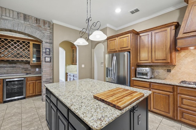 kitchen with stainless steel appliances, custom range hood, wine cooler, backsplash, and visible vents