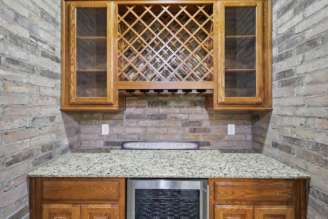 interior space featuring brick wall, a dry bar, and wine cooler