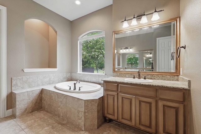 bathroom with vanity, tile patterned flooring, and a garden tub