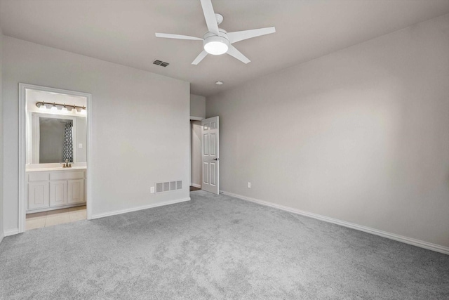 unfurnished bedroom with carpet floors, baseboards, and visible vents