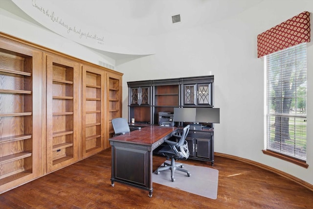 office space featuring visible vents, dark wood-style flooring, and a healthy amount of sunlight