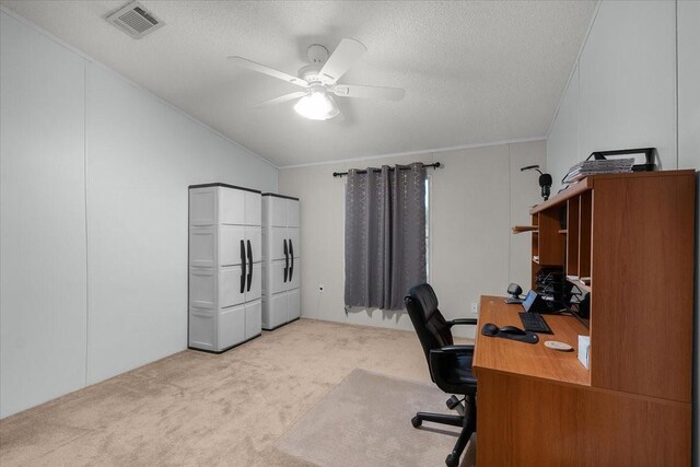 office area with visible vents, light carpet, a textured ceiling, a ceiling fan, and vaulted ceiling