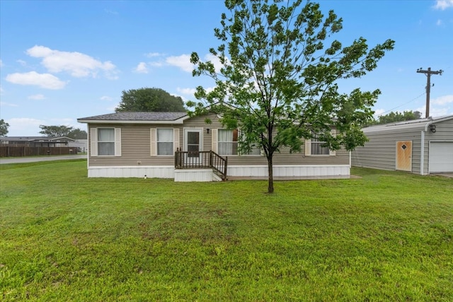 view of front of property featuring a garage and a front yard