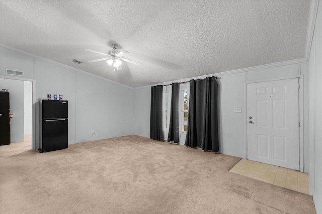 unfurnished living room featuring visible vents, carpet flooring, ceiling fan, and ornamental molding
