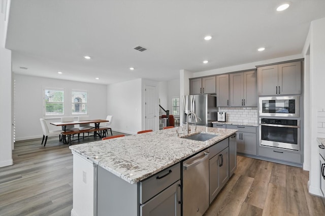 1210 Blazingstar Dr, Haslet, TX 76177 - kitchen featuring visible vents, a sink, appliances with stainless steel finishes, and gray cabinetry