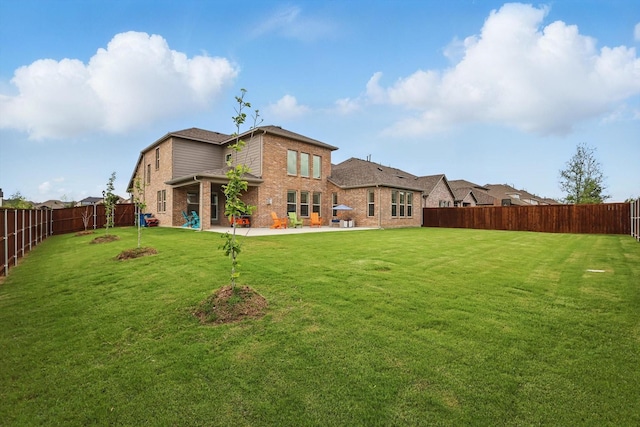 1210 Blazingstar Dr, Haslet, TX 76177 - rear view of house with brick siding, a fenced backyard, and a patio area