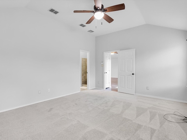 unfurnished bedroom with carpet floors, visible vents, and lofted ceiling