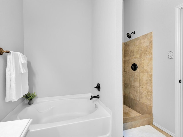 full bathroom with a garden tub and a tile shower