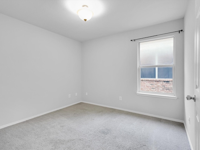 carpeted spare room with baseboards