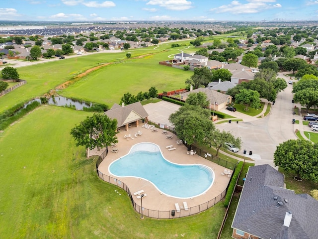 drone / aerial view featuring a residential view and a water view