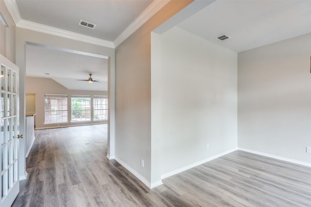 hall featuring baseboards, wood finished floors, and visible vents