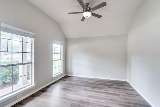 spare room with baseboards, a ceiling fan, wood finished floors, and lofted ceiling