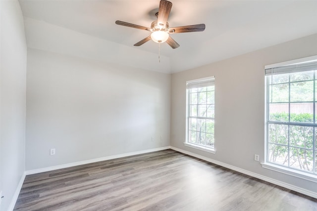 unfurnished room featuring baseboards, a ceiling fan, and wood finished floors