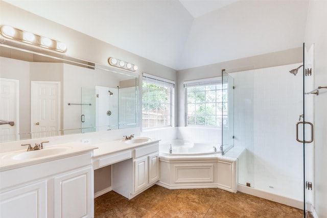 bathroom featuring a sink, a shower stall, a garden tub, and lofted ceiling