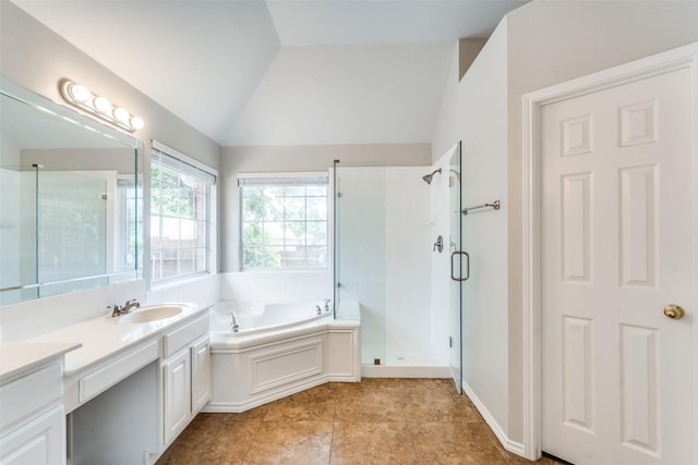 bathroom featuring a garden tub, a shower stall, vanity, tile patterned floors, and lofted ceiling