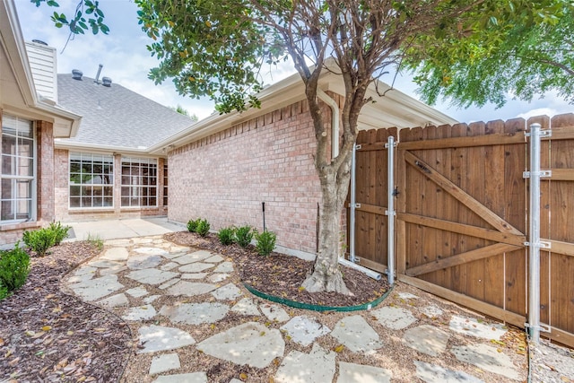 exterior space with a patio, a gate, and fence