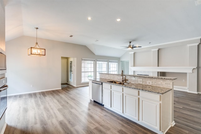 kitchen featuring open floor plan, vaulted ceiling, a sink, and dishwasher