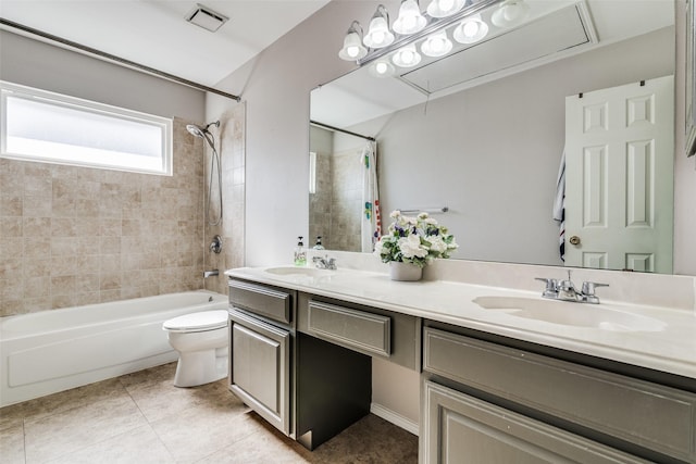 full bath with a sink, shower / bath combo with shower curtain, toilet, and visible vents