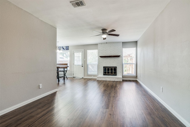 unfurnished living room featuring a healthy amount of sunlight, baseboards, a ceiling fan, and visible vents