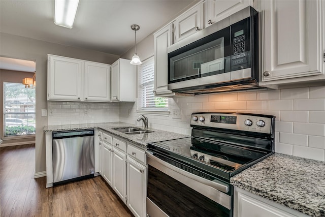 kitchen featuring a sink, appliances with stainless steel finishes, and white cabinets