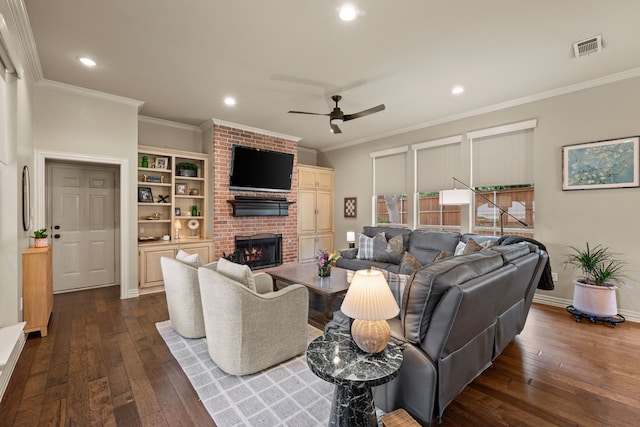 living room featuring ceiling fan, a brick fireplace, dark wood finished floors, recessed lighting, and visible vents