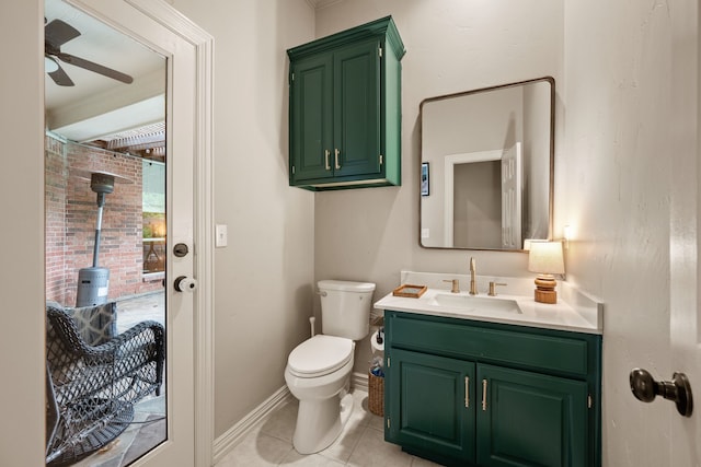 bathroom featuring a ceiling fan, vanity, tile patterned floors, baseboards, and toilet