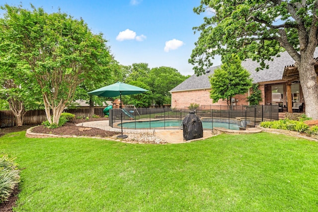 view of pool with a fenced in pool, a fenced backyard, a playground, and a yard