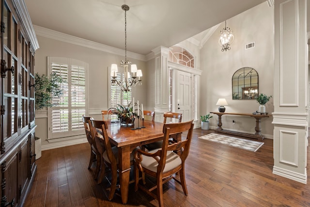 dining room featuring crown molding, dark wood finished floors, a chandelier, and visible vents