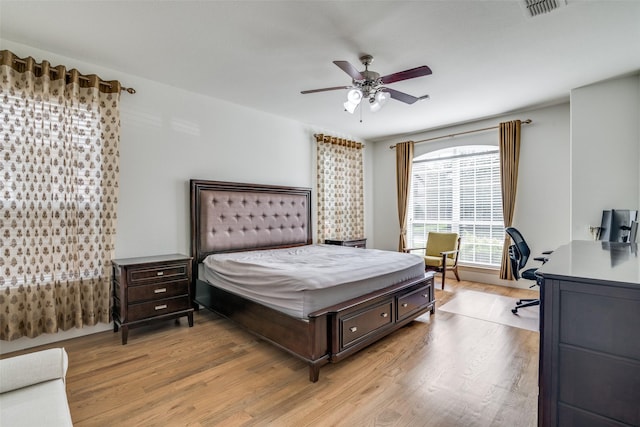 bedroom featuring ceiling fan, light wood-type flooring, and visible vents