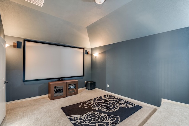 home theater with carpet floors, baseboards, visible vents, and lofted ceiling