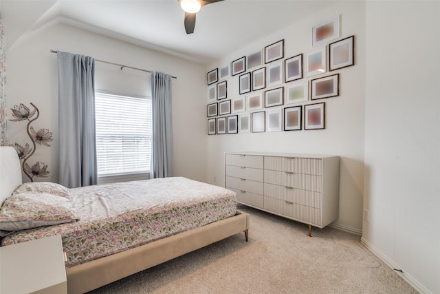 bedroom featuring baseboards, ceiling fan, and light carpet