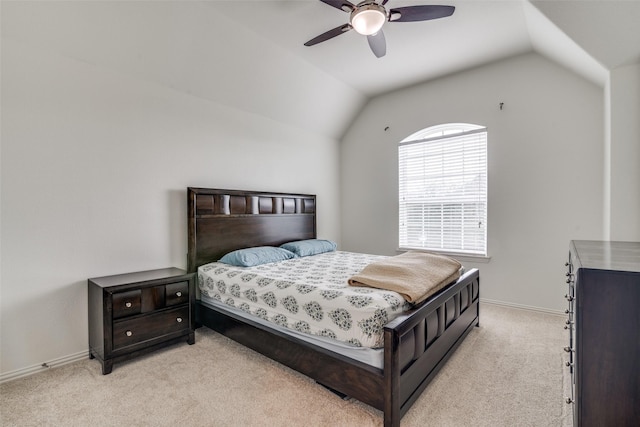 bedroom with baseboards, a ceiling fan, vaulted ceiling, and light colored carpet