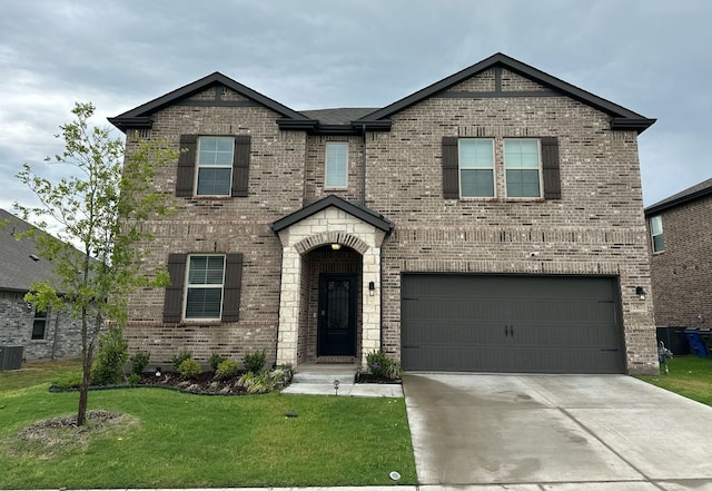 view of front of home featuring a front lawn, cooling unit, brick siding, an attached garage, and driveway