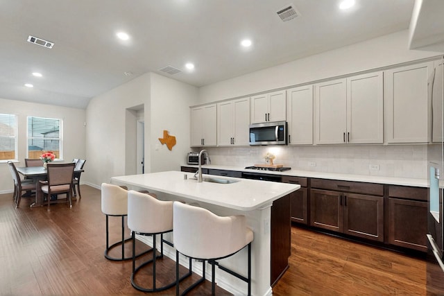 1907 Sandpiper Way, Princeton, TX 75407 - kitchen featuring a breakfast bar, appliances with stainless steel finishes, visible vents, and a sink