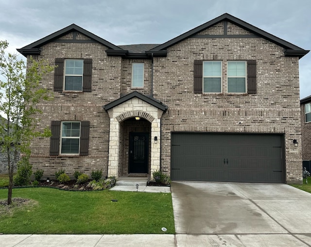 traditional-style home featuring a garage, concrete driveway, a front yard, and brick siding