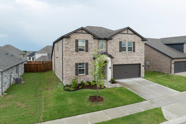1907 Sandpiper Way, Princeton, TX 75407 - view of front facade featuring brick siding, fence, a garage, concrete driveway, and a front yard
