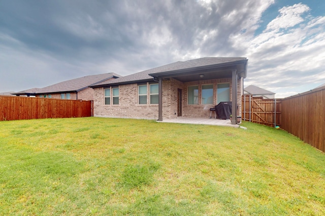 1907 Sandpiper Way, Princeton, TX 75407 - rear view of property featuring brick siding, a yard, a patio, a fenced backyard, and a shingled roof