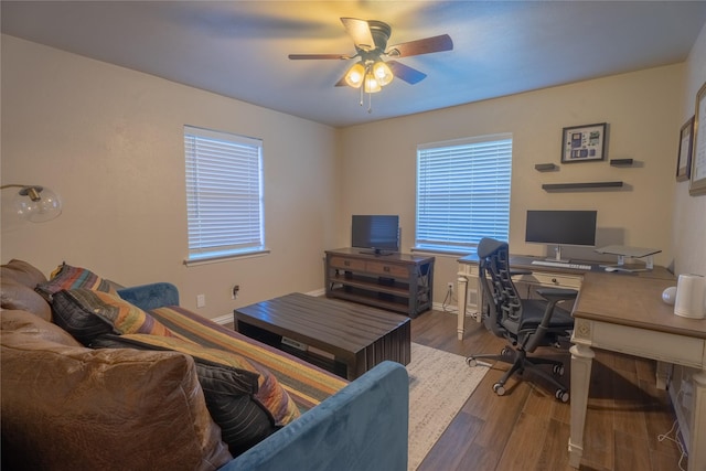 home office with baseboards, ceiling fan, a healthy amount of sunlight, and wood finished floors