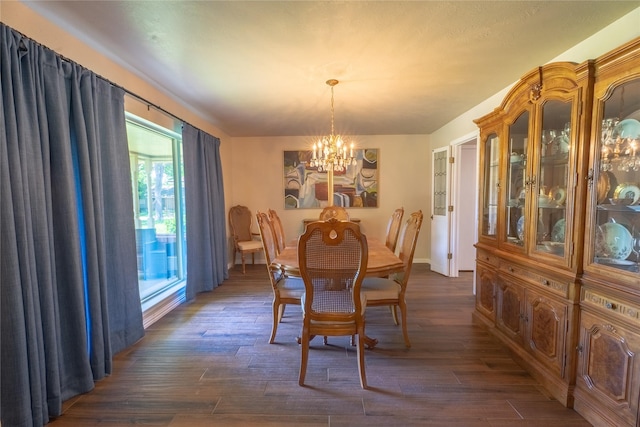 dining area featuring baseboards, dark wood-style flooring, and a notable chandelier