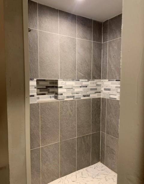 bathroom with tiled shower