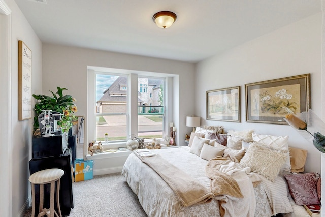 bedroom with baseboards and light colored carpet