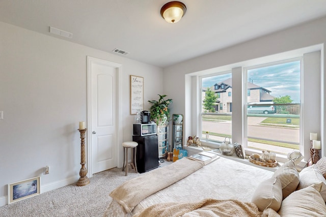 carpeted bedroom featuring baseboards and visible vents