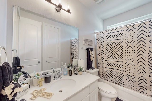 bathroom with toilet, shower / tub combo with curtain, and vanity