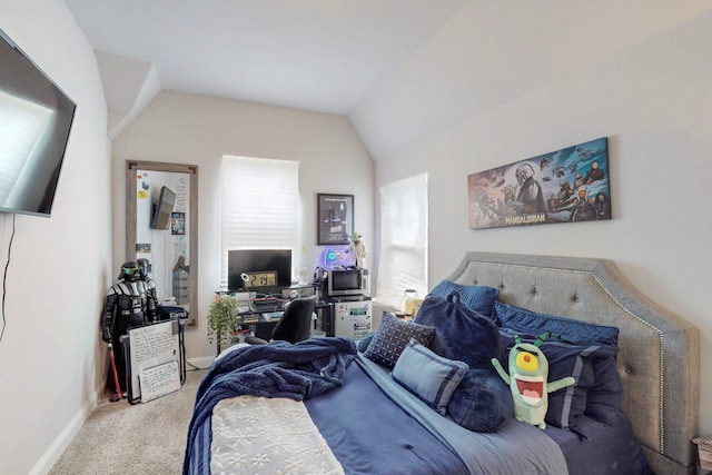 bedroom with carpet floors, baseboards, and lofted ceiling