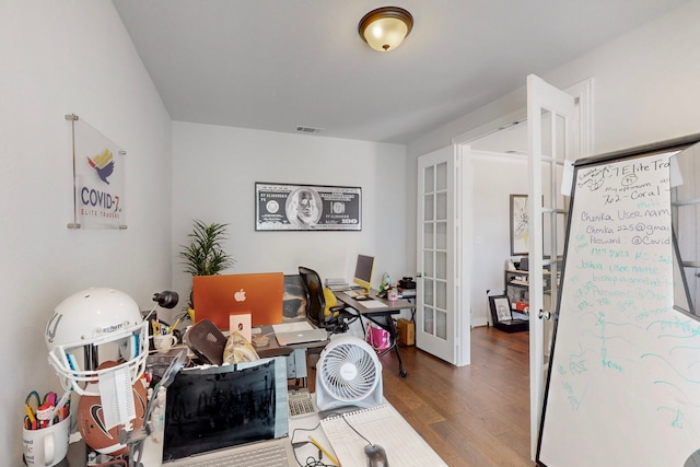 office area with french doors, wood finished floors, and visible vents